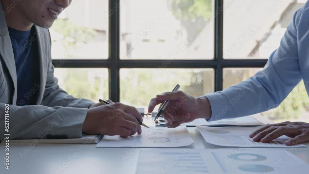 Poster close up of business person are discussed and brainstorming on paperwork that show accounting number