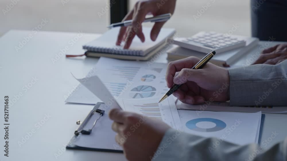 Poster close up of business person are discussed and brainstorming on paperwork that show accounting number