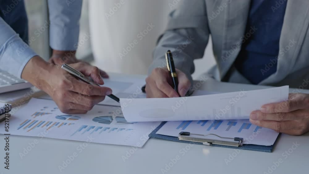 Poster close up of business person are discussed and brainstorming on paperwork that show accounting number