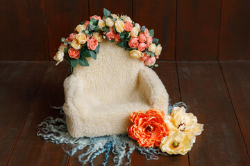 Shoot set up with sofa and a lot of flowers and green wool blanket on the wood background. Photo...