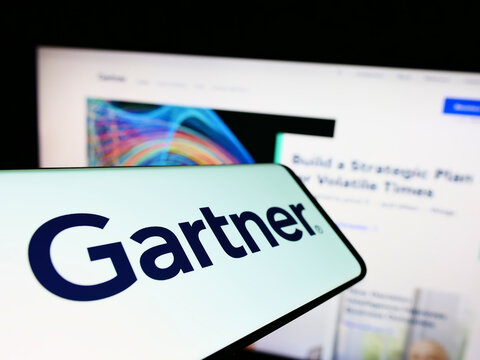 Stuttgart, Germany - 07-30-2022: Mobile phone with logo of American research company Gartner Inc. on screen in front of business website. Focus on center of phone display.