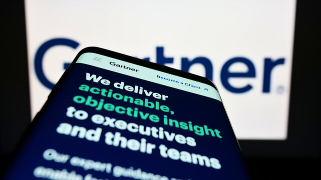 Stuttgart, Germany - 07-30-2022: Smartphone with website of US research company Gartner Inc. on screen in front of business logo. Focus on top-left of phone display.