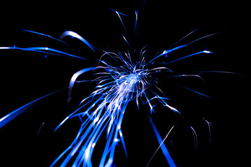 blue sparks in the dark. lines of light.