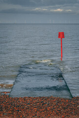 beach with wind farm in the distance