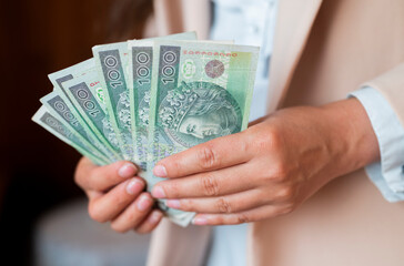 the girl holds in her hands banknotes money polish zlotys and pennies coins salary for payment