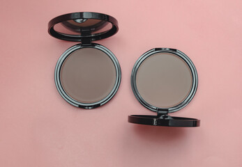 Top view eye shadow, blush, powder, sculptor in a case. pink isolated background, place for text. aesthetics of makeup artist, make-up, make-up for yourself, beauty, salon