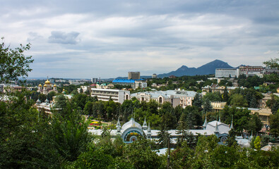 panoramic view of the historic city center with architecture among green trees and Mount Beshtau on the horizon on a cloudy summer day in Pyatigorsk Russia