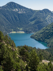 Fototapeta na wymiar view over a lower mand made reservoir lake, mountain setting 