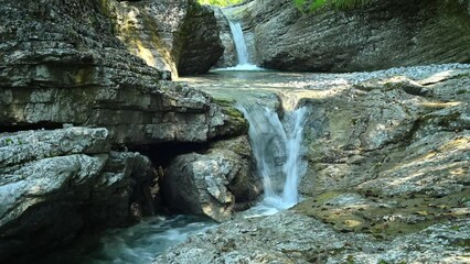 Beautiful waterfall between stones of a rivulet in the mountains
