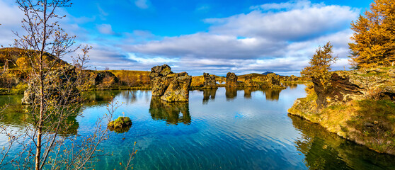 Amazing sunny day on lake Myvatn, Iceland, Europe. Volcanic rock formations reflected in the blue...