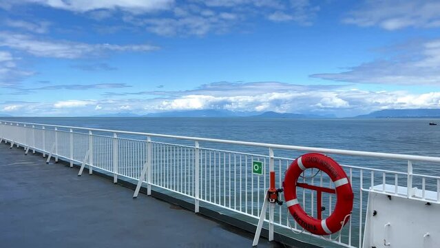 the deck of the ship is visible Only the white bridge and the red rescue circle as well as the sky The Pacific Ocean restless water on the sea Calm relax travel travel agency that will always save.