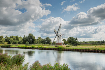 Polder landscape with canal and Witte Molen in Haren Glimmen in the Dutch province of Groningen to...