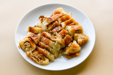 Homemade burek (borek)  with cheese and spinach and boiled egg.Traditional food. Peynirli, Patatesli, kiymali kol boregi.