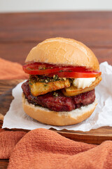 Choripan sandwich with chimichurri, sausage, tomato, mayo and cheese