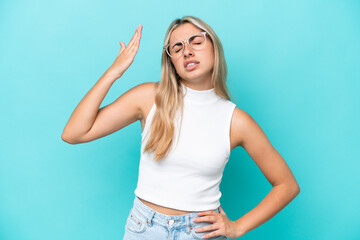 Fototapeta premium Young caucasian woman isolated on blue background with tired and sick expression