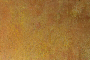 The yellow-orange texture of the aged concrete wall of an old house. Decorative textured plaster, inside surface finish at home. Abstract background with construction concept.