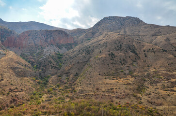 Armenian landscape with brick-red cliffs rock formations near Noravank monastery complex