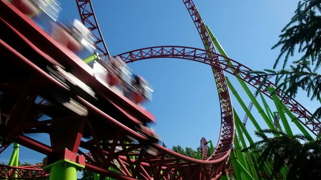 Roller coaster in the amusement park. Cheerful entertainments in park of attractions