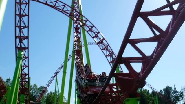 Roller coaster in the amusement park. Cheerful entertainments in park of attractions