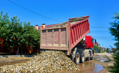 dump truck unloads crushed stone from the body © Alexander Lupin