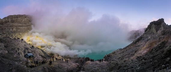 Panoramic scenery of the volcanic eruption smoke above the small lake