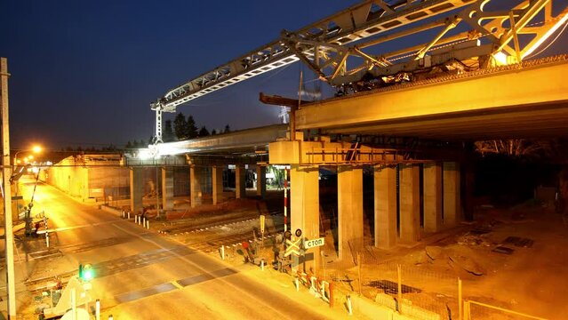 Timelapse of contemporary transport bridge over highway construction site for months. Road system improvement. Architectural development of vehicle traffic route