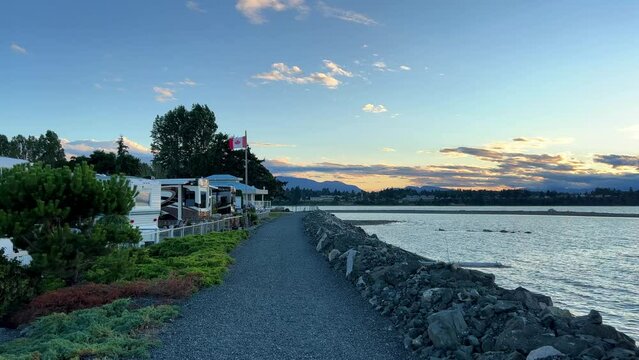 sunset on Ocean Horizon mountains are far visible many clouds and bright colors slow motion video suitable for music relaxation background For text silence peace Parksville beach Surfside RV resort