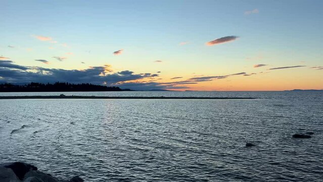 sunset on Ocean Horizon mountains are far visible many clouds and bright colors slow motion video suitable for music relaxation background For text silence peace Parksville beach Surfside RV resort