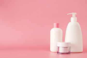 Cosmetics, Moisturizer, Bottle. Different cosmetic bottles. set of cosmetic products on pink background. Cosmetic package collection for cream, soups, foams, shampoo.