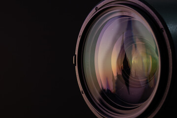 Marco shot of a lens in front of black background with asian temple reflection 
