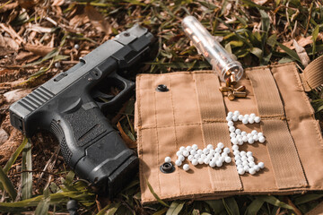 Airsoft gun with ammo on the ground