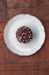 Chocolate cupcake served on a white plate