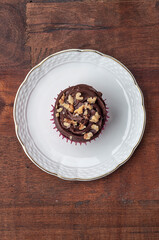 Chocolate cupcake served on a white plate