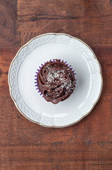 Chocolate cupcake served on a white plate