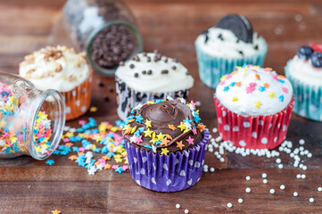 Colorful chocolate cupcakes with toppings