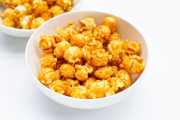 Honey caramel popcorn on white background.