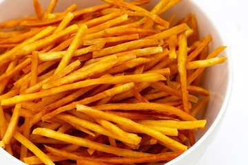 Sweet potato sticks on white background.