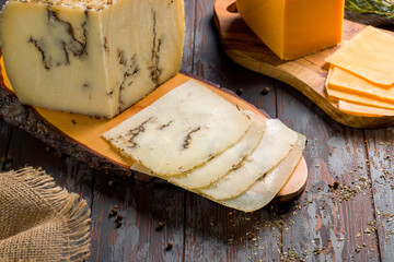 Cheese with truffles, Italian cheese on the board, sliced, moliterna