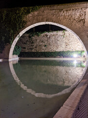 circle medieval of rock reflecting on the water perfect circle