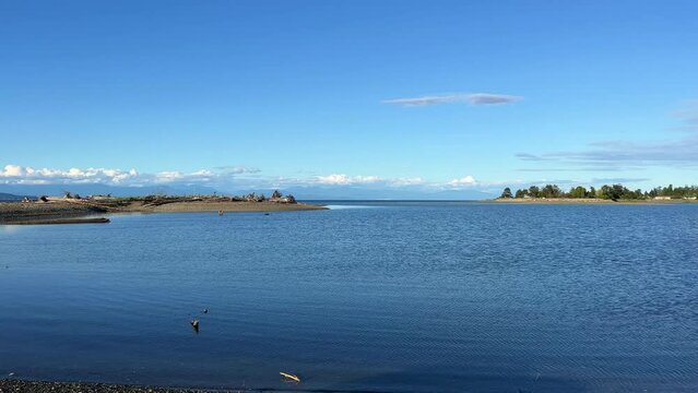 complete calm no wind no waves on pacific ocean looks like a lake on Vancouver island blue water silence calm tranquility and peace great place to relax background Parksville beach Surfside RV resort