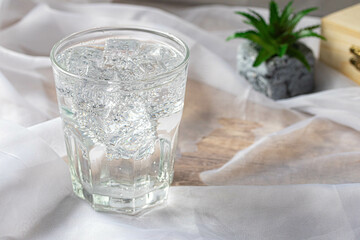 Soda water with ice in a clear glass. Copy space.