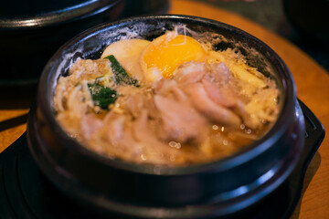Japanese cuisine Sukiyaki donburi with poached eggs and pork.