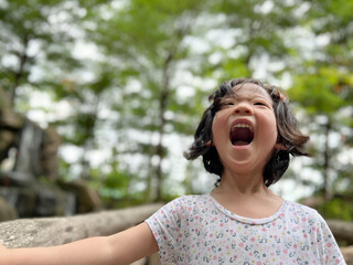 Cute little girl is laughing in the garden