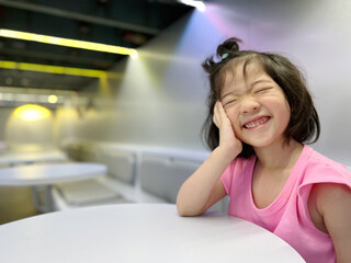 Beautiful girl laugh with big smile on the table with copy space in background