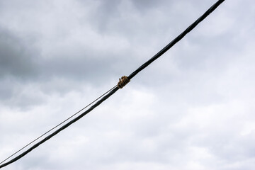 Electric cable against the sky
