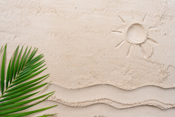 Fototapeta na wymiar Palm leaf on pattern sand beach background with waves and sun light.