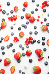 Various fresh berries on neutral background.
