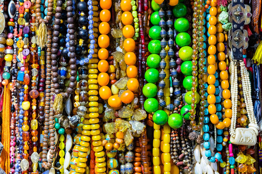 A collection of brightly coloured home made beads and necklaces.