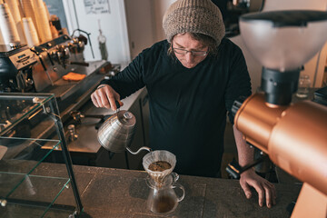 Hand drip coffee, Barista pouring water on coffee ground with filter