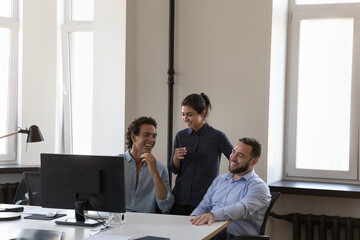 Happy positive multi ethnic colleagues joking laughing during break in work space, talking having...